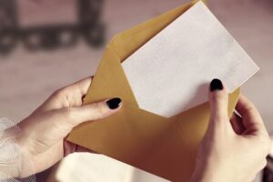 Woman putting card in an envelope