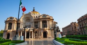 Palace of fine arts facade and Mexican flag