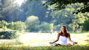 girl meditating alone in grass