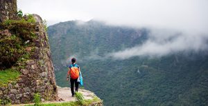 woman walking on edge peru