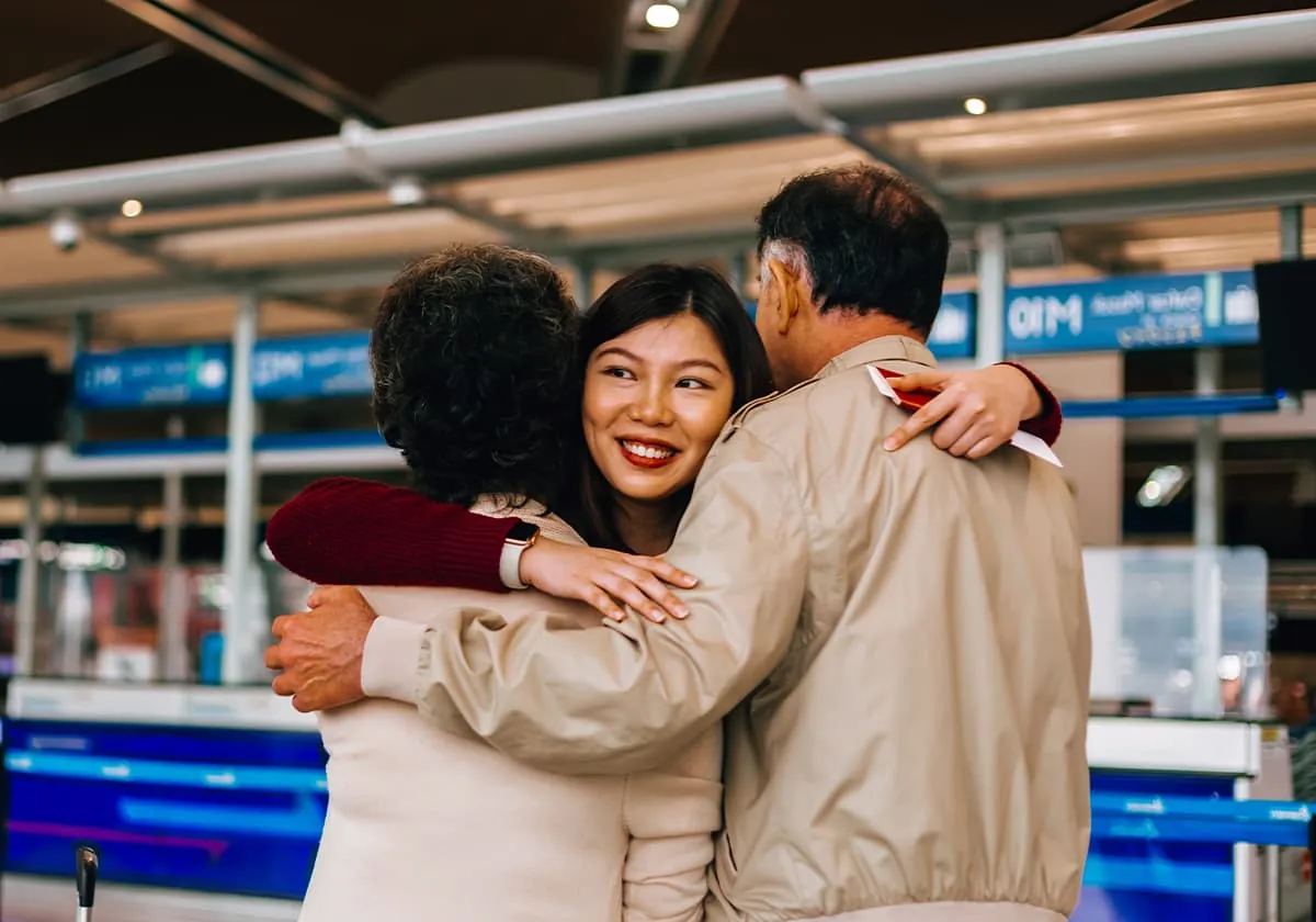 People hugging at transport station