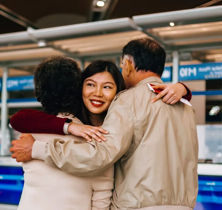 People hugging at transport station