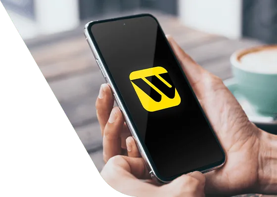 Person holding an iPhone using the Western Union app to send money to Ecuador